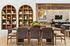 Elegant dining area with a large wooden table, stylish chairs, and decorative shelving in a modern apartment.