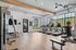 Bright, modern fitness center with large windows, treadmills, and weight machines.
