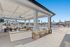 Luxurious outdoor patio overlooking a sparkling pool with stylish seating and modern design.