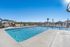 Inviting outdoor swimming pool with sun loungers and umbrellas on a sunny day.