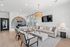 Modern apartment lounge with stylish decor, large chandelier, and cozy seating area.