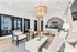 Stylish lounge area with modern seating, chic decor, and a statement chandelier.