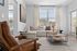 Bright and inviting living room with a large comfortable sofa and stylish decor.