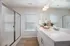 Primary bathroom with walk-in shower and double vanity