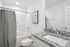 guest bathroom with shower tub combo