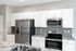 Modern kitchen with sleek stainless steel appliances, elegant white cabinetry, and a stylish tiled backsplash.