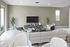 Modern living room featuring sleek furniture, natural lighting, and elegant decor with a large flat-screen TV for a stylish and comfortable ambiance.