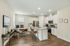 Modern open-plan kitchen with granite countertops, sleek stainless steel appliances, and cozy dining area. Ideal for entertaining and home office setup.