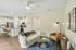Chic open-plan living space with a cozy sofa, stylish decor, modern kitchen, and elegant lighting.
