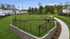 Charming suburban community with well-maintained lawns, secure fencing, and a scenic walking path surrounded by lush greenery.