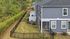 Charming townhouse with a fenced backyard and lush greenery, offering privacy and tranquility in a serene neighborhood.