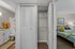 Inviting apartment interior featuring a cozy bedroom with vibrant decor, a modern bathroom with granite countertops, and ample closet space.