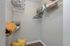 Spacious walk-in closet with sleek wooden flooring, ample shelving, and modern hangers for organized living.