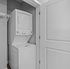 Chic apartment laundry nook with modern stackable washer and dryer set for convenient living.