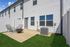 Charming backyard patio with cozy seating and modern fire pit, perfect for relaxation and entertaining guests.