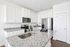 Modern kitchen with elegant granite countertops, sleek stainless steel appliances, and ample cabinet storage.