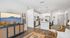 Chic open-plan living area featuring modern kitchen with island, inviting seating space, and elegant decor enhancing a serene atmosphere.