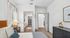 Bright and inviting bedroom with plush bedding, modern decor, and an elegant ensuite bathroom, showcasing contemporary comfort.