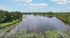Tranquil river view with lush greenery, perfect for nature enthusiasts seeking serene surroundings.