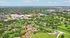 Vibrant aerial view of a sprawling amusement park, featuring exhilarating roller coasters, lush greenery, and scenic pathways.