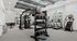 Modern fitness center with state-of-the-art equipment including treadmills, punching bag, and free weights, perfect for an invigorating workout experience.