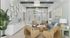Bright and airy living room featuring stylish wicker chairs, a modern blue sofa, and elegant decor with large windows for natural light.