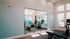 Contemporary home gym with exercise bikes, large mirror, and abundant natural light, perfect for fitness enthusiasts.