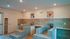Modern pet washing station featuring stylish tile floors, elevated bathing tubs, and cheerful dog portraits.